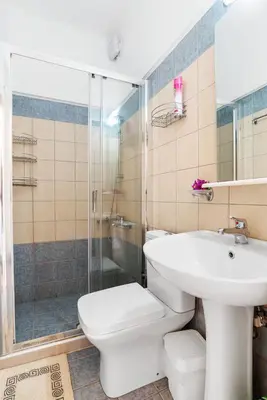 a bathroom with a toilet and a sink and a shower at Almyrida Bay View House II BY APOKORONAS-VILLAS in Almirida