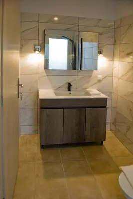 a bathroom with a sink and a mirror at Kandania Paradise in Kántanos