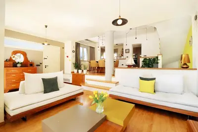 a living room with white furniture and yellow pillows at La Casa Di Fiori Stylish Holiday Home in Plataniás