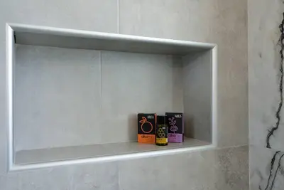two books are sitting on a shelf in a bathroom at Elma's Villa: A peaceful, family-friendly place in Daratso