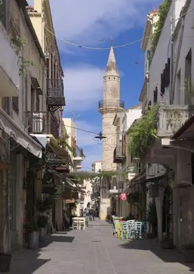 an alley with a clock tower in a city at Splatzia old town house in Chania Town