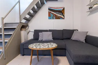 a living room with a couch and a table at Splatzia old town house in Chania Town