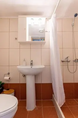 a bathroom with a sink and a toilet and a shower at Splatzia old town house in Chania Town
