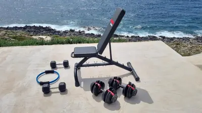 a gaming chair with dumbbells sitting on top of a wall at Luxury seafront design villa Kyma in Tersanas Owner listing in Tersanas