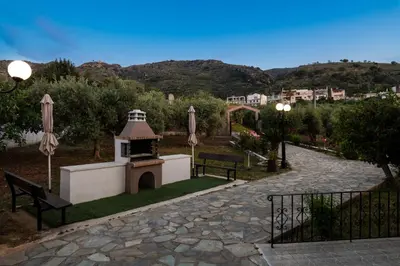a park with a gazebo and two benches at Garden House with Pool, 10min to center in Nerokoúros
