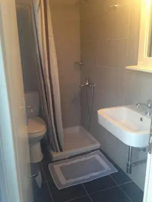 a bathroom with a toilet and a sink at Sofia Rooms in Loutro