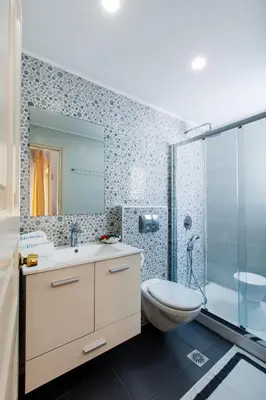 a bathroom with a sink and a toilet and a shower at Alkionides Seaside Hotel in Plataniás
