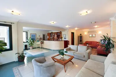 a large living room with couches and a table at Alkionides Seaside Hotel in Plataniás