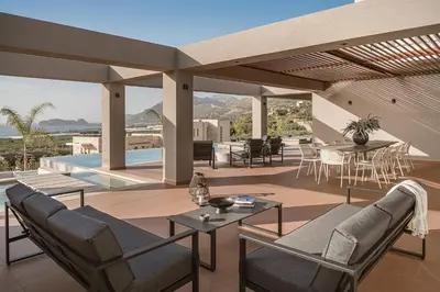an outdoor patio with a table and chairs and a view at Villa Aora Falassarna Beach I New luxury villa with infinity pool in Falasarna