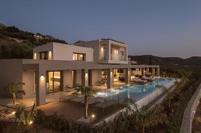 a large house with a swimming pool at night at Villa Aora Falassarna Beach I New luxury villa with infinity pool in Falasarna
