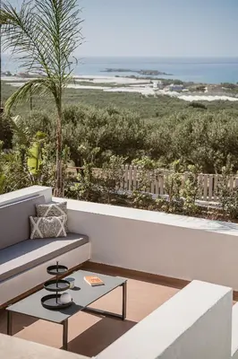 a living room with a couch and a view of the beach at Villa Aora Falassarna Beach I New luxury villa with infinity pool in Falasarna