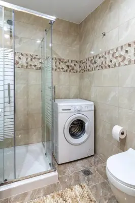 a bathroom with a washing machine and a shower at Nikolas City Home in Chania Town