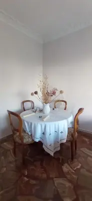 a white table with chairs and a vase of flowers on it at Spacious Sunny house in Chania in Chania Town