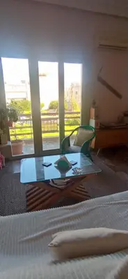 a room with a glass table in front of a bed at Spacious Sunny house in Chania in Chania Town