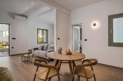 a living room with a table and a couch at Casa 28 City Apartments in Chania Town