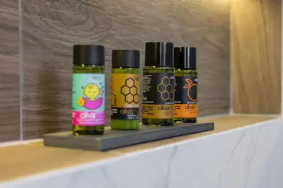 four bottles of essential oils sitting on a shelf at Casa 28 City Apartments in Chania Town
