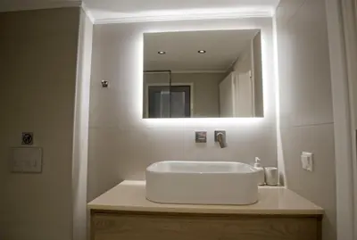 a white sink in a bathroom with a mirror at Villa Mourelo luxury villa in chania with private pool jacuzzi in Chania Town