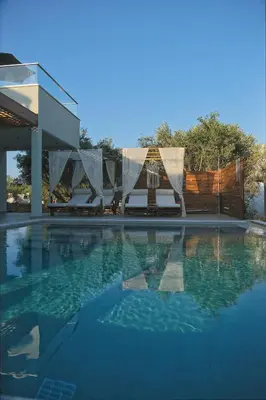 a swimming pool with a tent and a house at Villa Mourelo luxury villa in chania with private pool jacuzzi in Chania Town