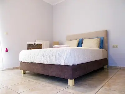 a bedroom with a large bed in a room at Stelia Apartment Gerani in Ayiá