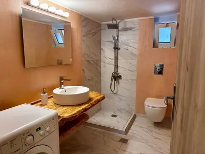 a bathroom with a sink and a toilet at Sophia's Smile in Kounoupidhianá
