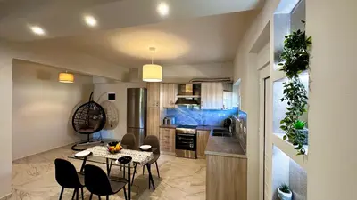 a kitchen with a table and chairs in a room at Sophia's Smile in Kounoupidhianá