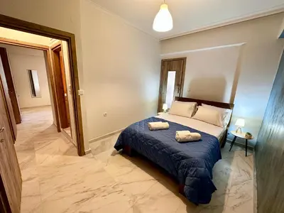a bedroom with a bed with two towels on it at Sophia's Smile in Kounoupidhianá