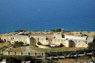 an old building on a hill next to the ocean at Anemole Traditional Cretan Villa in Megála Khoráfia