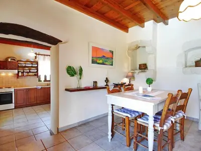 a kitchen and dining room with a table and chairs at Villa Ovgoro, Provarma, pool, seaview balcony in Próvarma