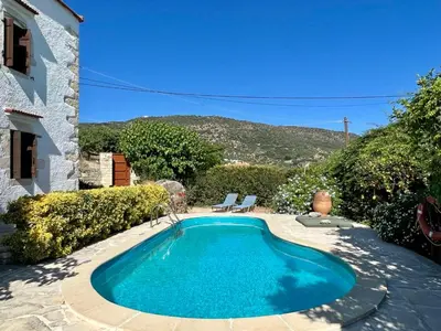 a swimming pool in the backyard of a house at Villa Ovgoro, Provarma, pool, seaview balcony in Próvarma