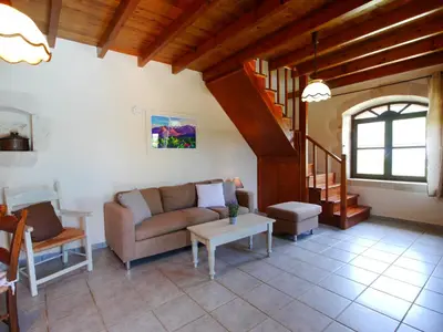 a living room with a couch and a table at Villa Ovgoro, Provarma, pool, seaview balcony in Próvarma