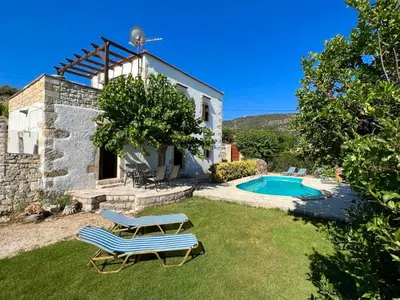 a house with a pool and a bench in the yard at Villa Ovgoro, Provarma, pool, seaview balcony in Próvarma