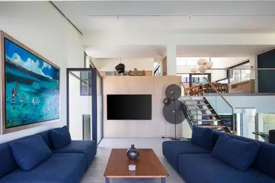 a living room with a blue couch and a tv at Villa St John - Wellness & Entertainment by etouri in Chania Town