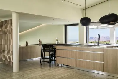 a kitchen with a counter and a bar with a window at Villa St John - Wellness & Entertainment by etouri in Chania Town