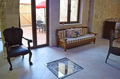 a living room with a couch and a chair at Venetian Cistern Villa in Kalamítsion Alexándrou
