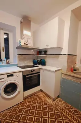 a kitchen with a washing machine and a washer at Beautiful house in the old town of Chania- 4 rooms in Chania Town
