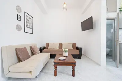 a living room with a couch and a coffee table at Elie's House next to the beach in Chania Town