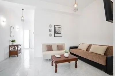 a living room with a couch and a coffee table at Elie's House next to the beach in Chania Town