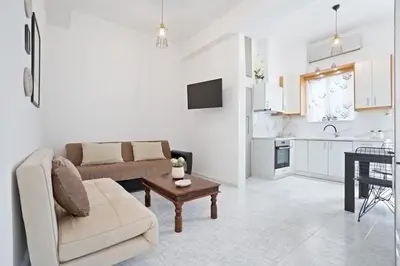 a living room with a couch and a table at Elie's House next to the beach in Chania Town