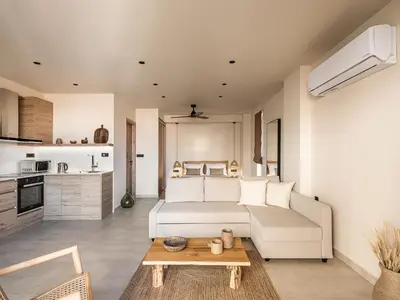 a living room with a couch and a table at Nomada Chania Apartments in Chania Town