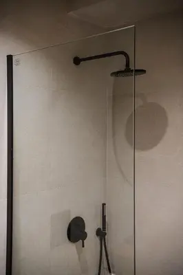 a shower with a glass door in a bathroom at Nomada Chania Apartments in Chania Town