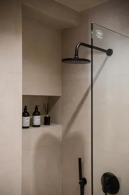 a shower with a glass door in a bathroom at Nomada Chania Apartments in Chania Town