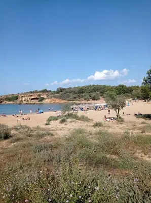 a beach with a bunch of people on it at Villa Ammos in Daratso