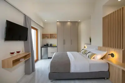 a bedroom with a large bed and a television at Chrysa Apartments in Chania Town