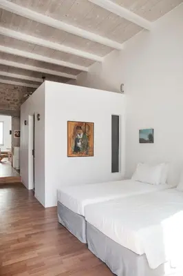 a bedroom with white walls and a large bed at Elorhouse in the charming neighborhood of KoumKapi in Chania Town