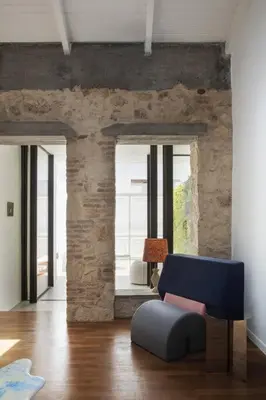 a living room with a blue chair and a couch at Elorhouse in the charming neighborhood of KoumKapi in Chania Town
