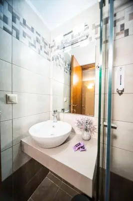 a bathroom with a sink and a mirror at Athena's House in Chania Town