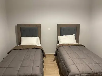 two beds sitting next to each other in a room at Jomaa luxury residence in Chania Town