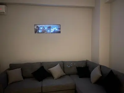 a living room with a gray couch with pillows at Jomaa luxury residence in Chania Town