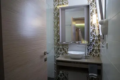 a bathroom with a sink and a mirror at Elia Potie in Chania Town