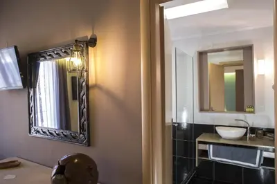 a bathroom with a sink and a mirror at Elia Potie in Chania Town
